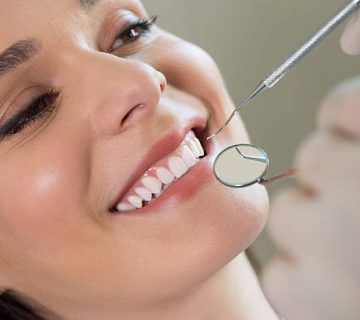 a young woman baring her teeth for the dentist to inspect 5