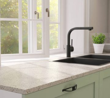 minimal and contemporary green kitchen counter with granite top and black quartz sink with
