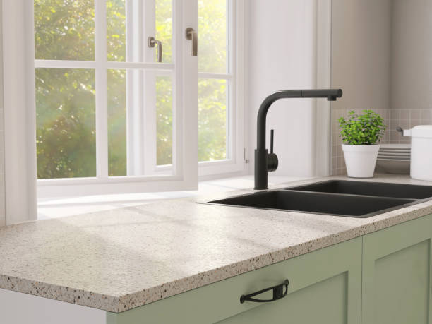 minimal and contemporary green kitchen counter with granite top and black quartz sink with