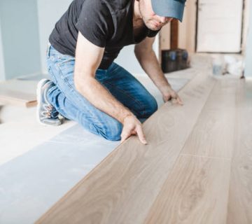 work of a master floating flooring installation installing laminate on the floor