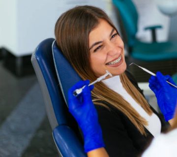 young woman at the dentist braces check up