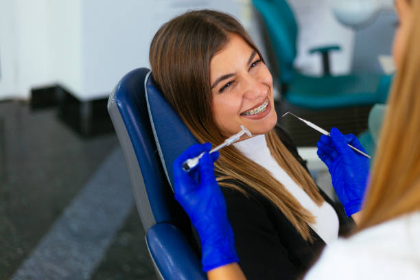 young woman at the dentist braces check up