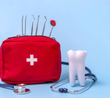 a model of a tooth a stethoscope a dentists tool a first aid kit concept first aid for 4