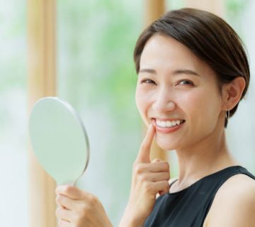 attractive asian woman wearing black dress looking mirror 2