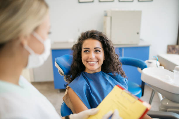 attractive young caucasian woman talking to her dentist