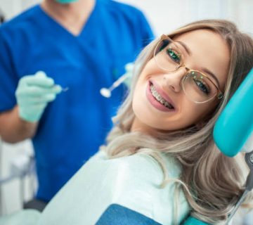 beautiful woman with braces having dental treatment at dentists office 1