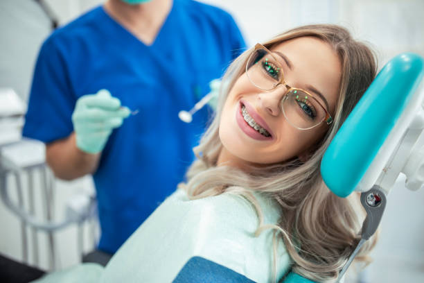 beautiful woman with braces having dental treatment at dentists office 1
