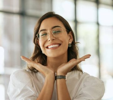 cheerful business woman with glasses posing with her hands under her face showing her smile 1