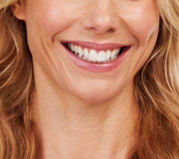 closeup smile and woman mouth in studio for dental hygiene or teeth whitening on grey