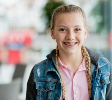 confident teenage girl with braces smiling at camera 1