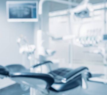 defocused background and copy space image of dental office with dentist chair and equipment 1