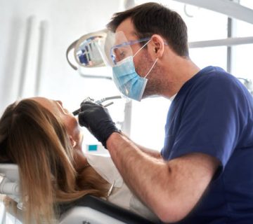 dentist drilling in teeth of the patient