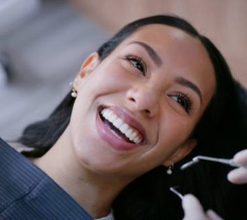 dentist woman and smile with mirror for teeth whitening oral hygiene and consultation with 1