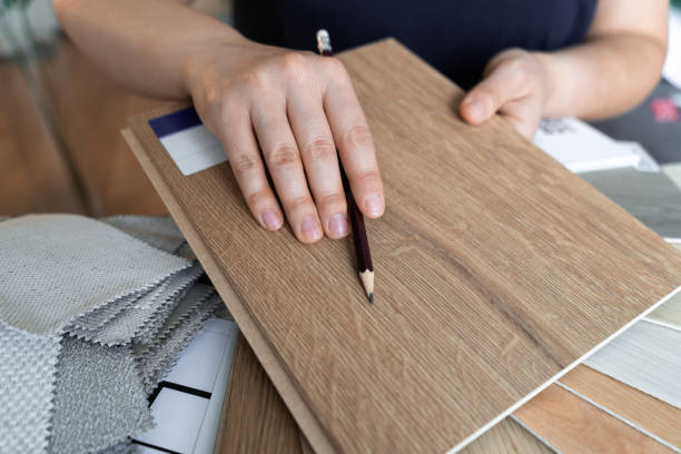 female interior designer showing wood flooring samples assisting clients in choosing shades