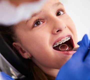 girl with braces during a routine dental examination