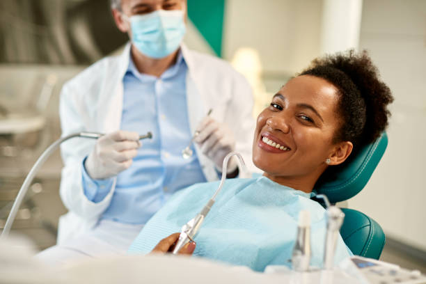happy black woman at dentists office looking at camera