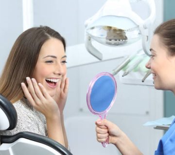 happy dentist patient checking whitening results 2