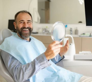 happy male patient enjoying after teeth whitening at the dentists 1