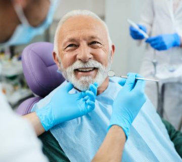 happy senior man having dental treatment at dentists office 3