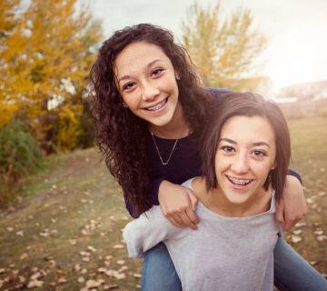 hispanic teenage girls having fun together outdoors 1