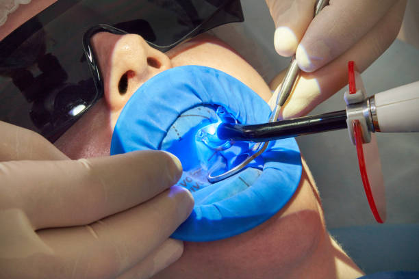 patient getting dental treatment at dentist office with dental rubber dam protection