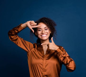 photo of good mood funny lady wear silk brown shirt spectacles showing arms photo gesture