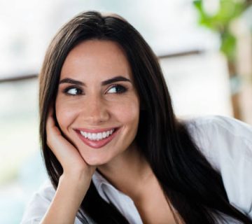 photo of stunning adorable young lady hand touch cheek beaming smile imagine contemplate