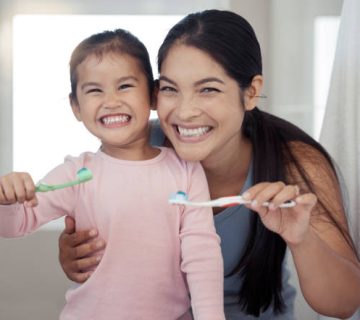 portrait of mom and kid brushing teeth dental healthy and cleaning in bathroom at home happy 2