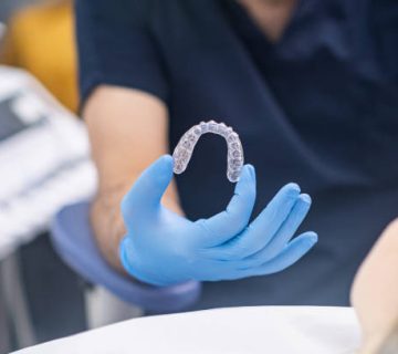 professional orthodontist showing innovative aligners to camera designed for bite correction
