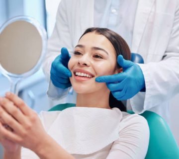 shot of a young woman checking her results in the dentists office 4