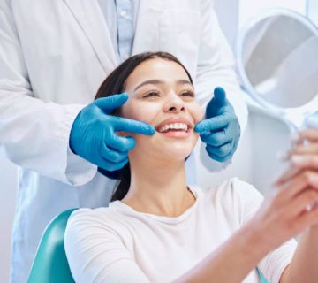 shot of a young woman checking her results in the dentists office 5