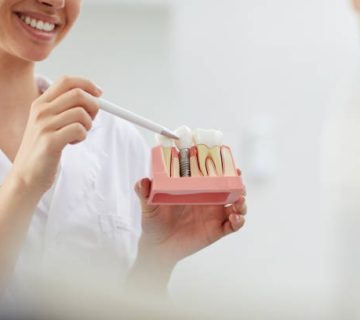 smiling dentist explaining tooth implantation 3