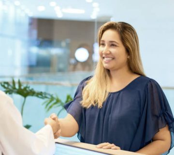 smiling female patient shaking hand on doctor
