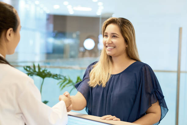 smiling female patient shaking hand on doctor