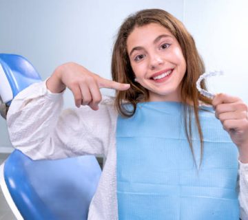 teenage girl goes to the dentist to receive modern orthodontic treatment to correct the