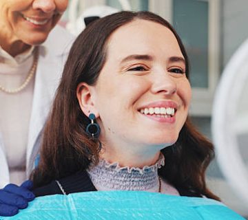 teeth smile and mirror with woman at dentist for dental care treatment and fresh breath