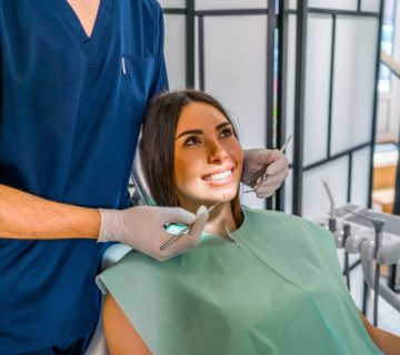 woman examining her teeth at the dentist