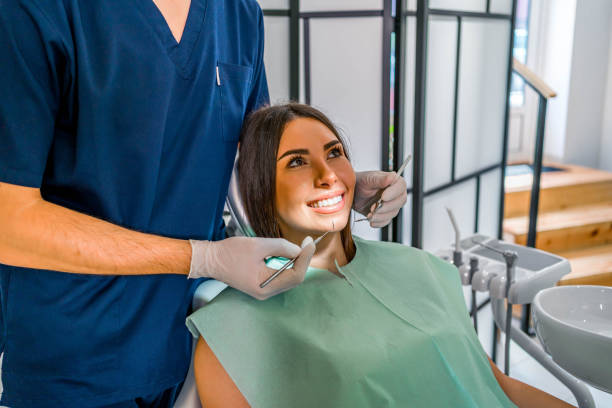 woman examining her teeth at the dentist