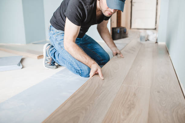 work of a master floating flooring installation installing laminate on the floor