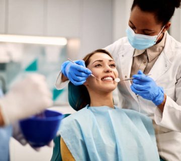 young smiling woman having dental exam at dentists office 1