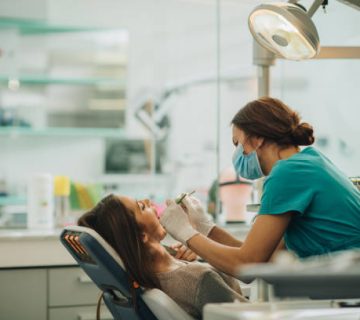 young woman having her teeth checked during appointment at dentists office 1